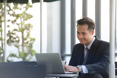 Young,Asian,Businessman,Working,With,Laptop,Computer,At,Outdoor,Cafe