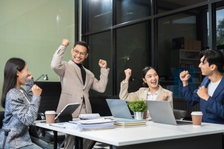 Group of Young Asian business team creative businesspeople coworker in office Happy to be successful partnership teamwork success concept.