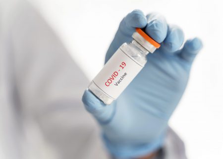 close-up-doctor-holding-vaccine-recipient-her-hand